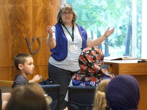 Rabbi Debra Stahlberg Dressler, seen here discussing her faith with young visitors to Temple Israel of London in 2016, says the inability to gather amid the pandemic has been hard on many of her congregants. (Free Press files)