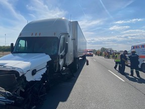 The driver of a tractor trailer suffered serious injuries when it crashed at about 4 p.m. Monday into the back of truck travelling behind a road-painting vehicle on Highway 401 near West Lorne, Elgin OPP said. (OPP photo)