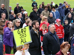 Independent MP Derek Sloan, front row, centre, listens during an anti-lockdown protest Monday, April 26, 2021, at Tecumseh Park in Chatham. (Mark Malone/Chatham Daily News/Postmedia Network)