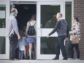 People enter Harvest Bible Church in Windsor on Sunday, many without mask coverings, in defiance of provincial health orders.