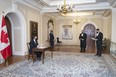 In this March 31 photo, Richard Wagner, the Administrator of the Government of Canada, attends a socially distanced signing ceremony at Rideau Hall for two new bills.