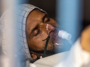 A patient receives treatment in the COVID-19 ward of a government-run hospital in Bijnor district, Uttar Pradesh. India is facing a crushing third wave; the threat of additional variants looms.