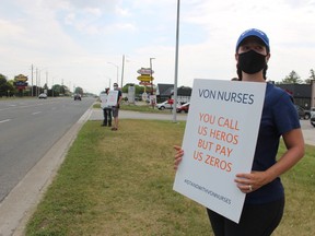 Danielle Chappelle holds a sign Tuesday outside the VON office in Sarnia. The registered practical nurse is one of about 23 LiUNA Local 3000 members working for VON who have been on strike since May 1.