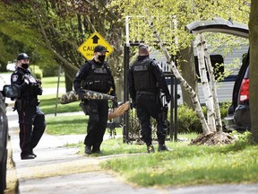 Woodstock police remove items from a home on East Park Drive in Woodstock on Wednesday, May 5, 2021. Two men are charged with weapons and drug offences. (Kathleen Saylors/Woodstock Sentinel-Review)