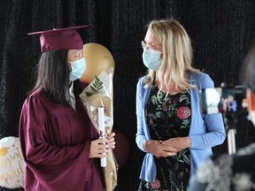 Graduate Jane Lee is congratulated by Banting secondary school vice-principal Christine Holmes on Friday. DALE CARRUTHERS / THE LONDON FREE PRESS