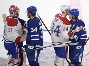 Toronto Maple Leafs forwards Auston Matthews (34) and Mitch Marner (16) shake hands with Montreal Canadiens goalie Carey Price (31) and forward Corey Perry (94) after the Canadiens beat the Leafs 3-1 in Game Seven of the first round of the 2021 Stanley Cup Playoffs at Scotiabank Arena on May 31, 2021. Dan Hamilton-USA TODAY Sports.