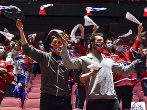 Fans take in the atmosphere during the pre-game ceremony between the Montreal Canadiens and the Toronto Maple Leafs in Game 6 of the first round of the 2021 Stanley Cup Playoffs at the Bell Centre in Montrael on Saturday, May 29, 2021.