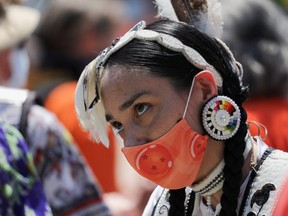 A protester takes part in a march from the Ontario provincial legislature, after the remains of 215 children were found on the grounds of the Kamloops Indian Residential School, in Toronto, Ontario, Canada June 6, 2021. (REUTERS/Chris Helgren)