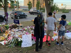 London Sana Ahmed, 35, stands with her sons Shazeb and Musa at the memorial where four members of London's Afzaal family were killed in a hit-and-run police allege was motivated by anti-Muslim hate. (Patrick Maloney/The London Free Press)