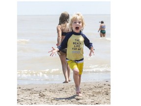 Three-year-old Aito Pihlainen of London runs from the waves at Little Beach in Port Stanley on Sunday June 27, 2021. He was there with his parents Rebecca and Drew as well as his twin brother Piet. Derek Ruttan/The London Free Press