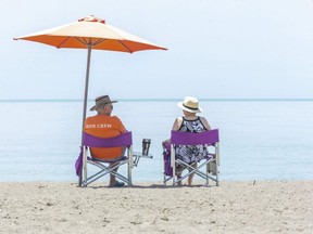Randy and Tina McLeod of St. Thomas enjoy a day at the beach in Port Stanley. (Derek Ruttan/The London Free Press)