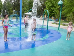 Six-year-old Rylan Manford gets soaked while playing at the Rotary Club of St. Thomas Centennial Splash Pad in Pinafore Park on Wednesday. Also cooling off were, left to right, Hannah Thomas, 9, Liam Fugard, 9, and Aurora Milne, 4. (Derek Ruttan/The London Free Press)