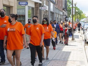 About 300 people took part in the Every Child Matters March through downtown St. Thomas Ont. on Monday. They marched from the Holy Angels Parish to the St. Thomas Anglican Church and back. Participants laid tokens of remembrance (mostly children's shoe and stuffed animals) on the steps of both houses of worship for the 215 children found in unmarked graves at the Kamloops Residential School as well as all those lost at other residential schools, the survivors and their families. Event organizer Betty Jean Phillips Budden explained the purpose to the tokens."(We laid) our tokens at their doorsteps so that they know we hold them accountable." Derek Ruttan/The London Free Press/Postmedia Network