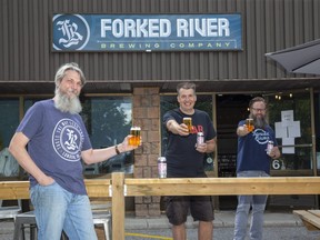 Speed City Records owner Mike Todd, centre, and Forked River Brewing co-owners Andrew Peters, left, and Dave Reed  have created a beer called Sparton Press Pils, honouring the former record manufacturing company in London. (Derek Ruttan/The London Free Press)