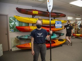 London's Paddle Shop sales associates Ashley Govers, left, and Jennifer Kessler have a rack of kayaks, but they're all pre-sold -- a sign of the kayak's popularity this summer as the pandemic continues to keep us physically distanced. (Derek Ruttan/The London Free Press)