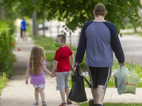 Jordan Monteith enjoys walking to get groceries in Old South with his two children Emma,4 and Brian, 6 in London, Ont. "We just love the walk," said Monteith who said it was only a few blocks and exercise is always good. (Mike Hensen/The London Free Press)