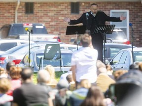 Rev. Henry Hildebrandt preaches to a large crowd of hundreds of people who were at the outdoor church service at the Aylmer Church of God on Sunday. (Mike Hensen/The London Free Press)