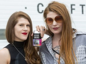 Morgan and Mercedes Lander of Kittie hold up the Anderson Ale beer with their band on the label, crafted for the London Music Hall of Fame. (Mike Hensen/The London Free Press)