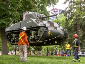 London's famous Holy Roller Sherman tank is hoisted off its plinth in Victoria Park Tuesday for a short trip to Fanshawe College, where the aging memorial will be refurbished by volunteers and Fanshawe students over the next year. (Mike Hensen/The London Free Press)