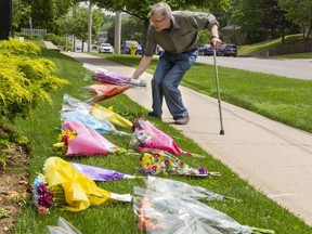 Richard Clarke of London walked to the front of the London Muslim Mosque on Tuesday, June 8, 2021 to place flowers for the family of Salman Afzaal. "From our family to theirs," Clarke said. Afzaal, his wife Madiha Salman, mother and daughter Yumna died Sunday after they were struck by pickup truck while walking in what police say was a targeted act because they were Muslims. Afzaal's son Fayez was injured. (Mike Hensen/The London Free Press)