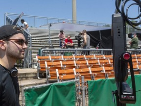 Director Ethan Hickey looks in the monitor as they start to block out a scene Thursday, June 10, 2021 in Labatt Park for Hickey's new movie, Burden. (Mike Hensen/The London Free Press)