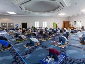 Worshippers pray Friday June 11, 2021, at the London Muslim Mosque. It is the first time Friday prayers have been held in person at the mosque since April as the province moved into Step 1 of its reopening plan, allowing indoor religious services at up to 15 per cent capacity. It's also the first public Friday prayers since the death of four members of a Muslim family who police said were targeted because of their faith last Sunday in London. Instead of a full house, the mosque is holding four periods of prayer, one after the other, so more people can attend. (Mike Hensen/The London Free Press)