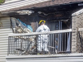 A London fire prevention inspector surveys the damage on a second-floor balcony after a $200,000 blaze damaged two units of a townhouse complex at 700 Osgood Dr. Tuesday morning. (Mike Hensen/The London Free Press)