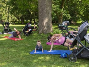 Calvin Ross, 3, exercises along with his mom Hayley Ross as part of a Stroller Bootcamp run by Andfit in Springbank Park in London. (Mike Hensen/The London Free Press)