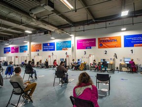 People wait to receive the Pfizer-BioNTech COVID-19 vaccine in Worcester, Mass., in April.