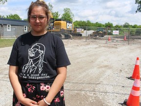 Jada Henry stands in front of a property near where her family lives on River Road at Aamjiwnaang First Nation Thursday. A group of neighbours and community residents gathered there to stop construction on a gas station.