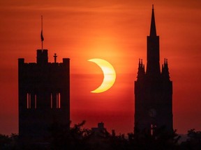 A solar eclipse is seen framed by two towers on Western University's campus on Thursday, June 10, 2021. (CREDIT: Allan Leparskas/Western University)