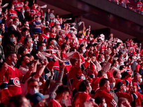 Montreal Canadiens fans watch warm-ups prior to Game Four against the Tampa Bay Lightning in the 2021 NHL Stanley Cup Final at the Bell Centre on July 05, 2021 in Montreal, Quebec, Canada. (Photo by Minas Panagiotakis/Getty Images)
