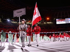 Canadian flag bearers Nathan Hirayama and Miranda Ayim lead their contingent during the athletes' parade at the opening ceremony July 23.