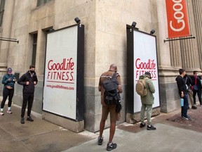 Goodlife Fitness clients line up as they wait for the doors to open on the downtown Calgary location on Thursday, June 10, 2021. (Postmedia Network)