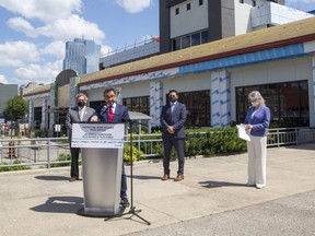 Federal transport minister Omar Alghabra speaks at the Via Rail station in London while flanked by Mayor Ed Holder (left), London North Centre MP Peter Fragiskatos and London West MP Kate Young on Wednesday July 21, 2021. (Derek Ruttan/The London Free Press)