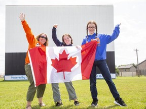 Friends of Maggie Mac Neil (left to right) Tamara Thompson and her daughters Graceyn, 16, and Larkyn, 15, will be cheering as they watch her Olympic race on the big screen at the Oxford Drive-In  in Woodstock. this Sunday. The club has rented it out to support the swimming star. (Derek Ruttan/The London Free Press)