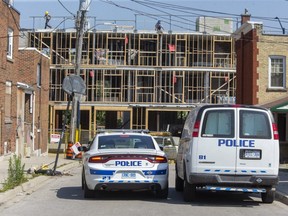 Police vehicles were parked on Hewitt Street at King Street during an investigation into a Sunday evening shooting. Photo shot in London on Monday July 26, 2021. (Derek Ruttan/The London Free Press)