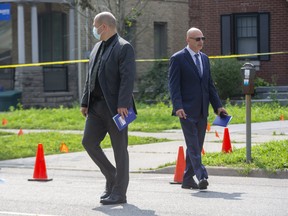 London police detectives canvass Dufferin Avenue in downtown London, where a police officer shot a man on Tuesday night. Photo taken on Wednesday July 28, 2021. Derek Ruttan/The London Free Press