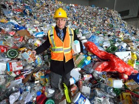 Jay Stanford, director of environmental, fleet and waste services with the City of London, stands in a pile of garbage waiting to be recycled. (File photo)