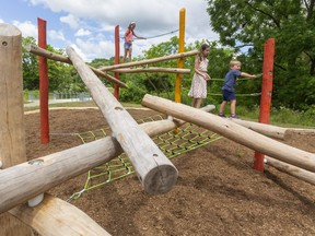 Josh Morgan family kids McKenna, 10, Ainsley, 12, and Max, 5 at the new "naturalized playground," in London located in Kiwanis Park in London, Ont. (Mike Hensen/The London Free Press)