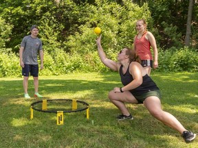 Felix Dechsler left, awaits the pass from teammate Lesley Kukoly in a spirited game of Spike Ball in Thames Park against Zach Johnston and Jenna Crocker.  (Mike Hensen/The London Free Press)