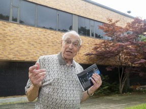 Bill Brady poses with his new book, It's All About Me, in front of the York Street building that once was home to CFPL radio on Tuesday, July 13, 2021 in London. (Mike Hensen/The London Free Press)