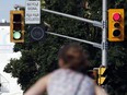 A woman waits for the bicycle signal in this file photo. (Postmedia Network file photo)