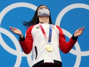 A joyous Maggie Mac Neil of London reacts after getting the gold medal for the women's 100m butterfly at the Tokyo Olympics. It was Canada's first gold of the Games. (REUTERS/Kai Pfaffenbach)