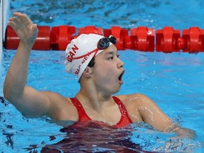 Londoner Maggie Mac Neil celebrates after winning Canada's first gold medal at the Summer Olympics in Tokyo in the 100-metre butterfly. Mac Neil said Tuesday she's reached a sponsorship deal with swimsuit maker Speedo. (AL BELLO /Getty Images)