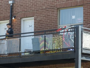 A police constable is posted outside a King Street apartment where a man was arrested after another man was shot on Sunday evening. Derek Ruttan/The London Free Press/Postmedia Network
