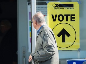 In this file photo, s man arrives to cast his ballot at a polling station on federal election day in Shawinigan, Que., on Oct. 21, 2019.