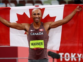 Damian Warner of London celebrates Aug. 5 after winning gold in men's decathlon at the Tokyo Olympics. Warner was named Canada's athlete of the year on Wednesday.
