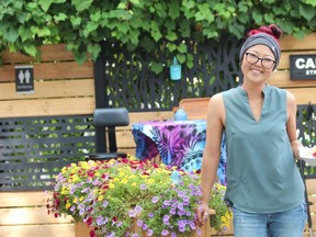 London entrepreneur Laura Bradley holds a plate of French toast during Sunday brunch at Behind the Bend, a cannabis consumption cafe located behind her marijuana retail store on Main Street in Grand Bend. Photo taken Sunday Aug. 22, 2021. Dale Carruthers / The London Free Press