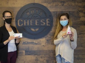 Nuts For Cheese quality control assurance manager Leigh Cookson (left) holds vegan unsalted butter and business development manager Candace Campbell holds vegan cheese. (Derek Ruttan/The London Free Press)